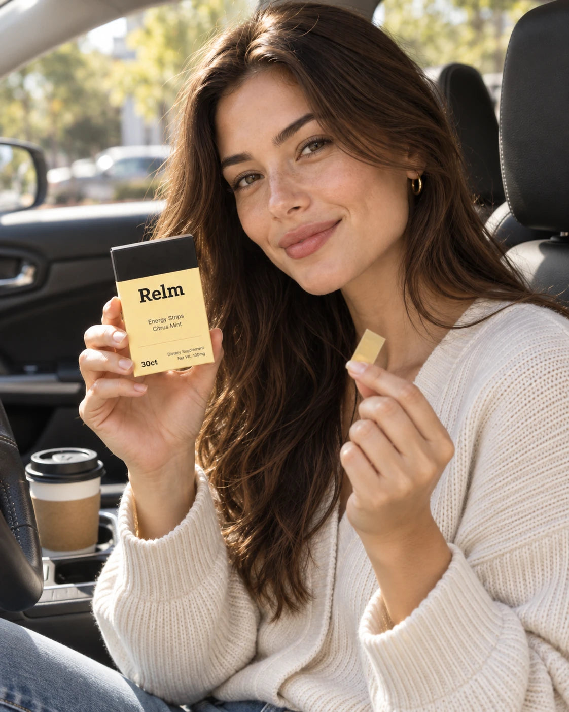 A woman in the driver's seat holding a Relm pack and a single strip